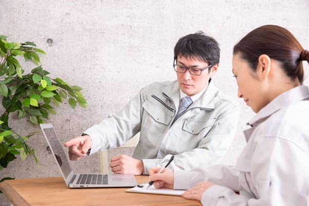 PCを指さしながら指示をする男性